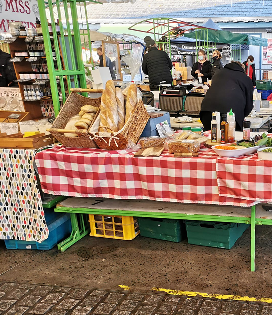Bakery stall with artisan bread and treats on red gingham table
