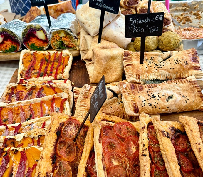 Display of assorted savory pastries at a food markets
